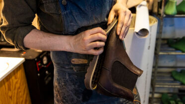 Ein Schuhmacher repariert ein Paar gebrauchte Schuhe und bereitet sie für den erneuten Verkauf vor. Foto: Michael Campanella © European Union, 2022